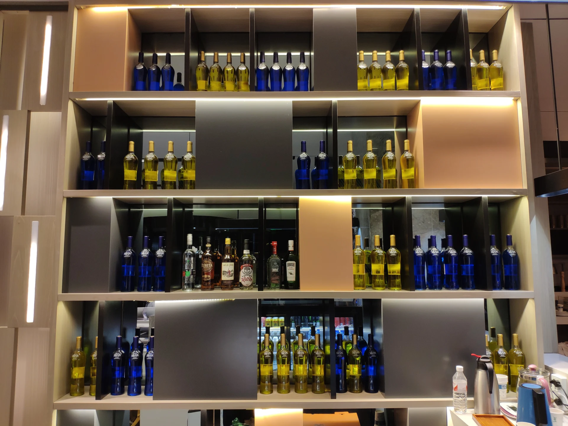 Illuminated backbar — layered metal display