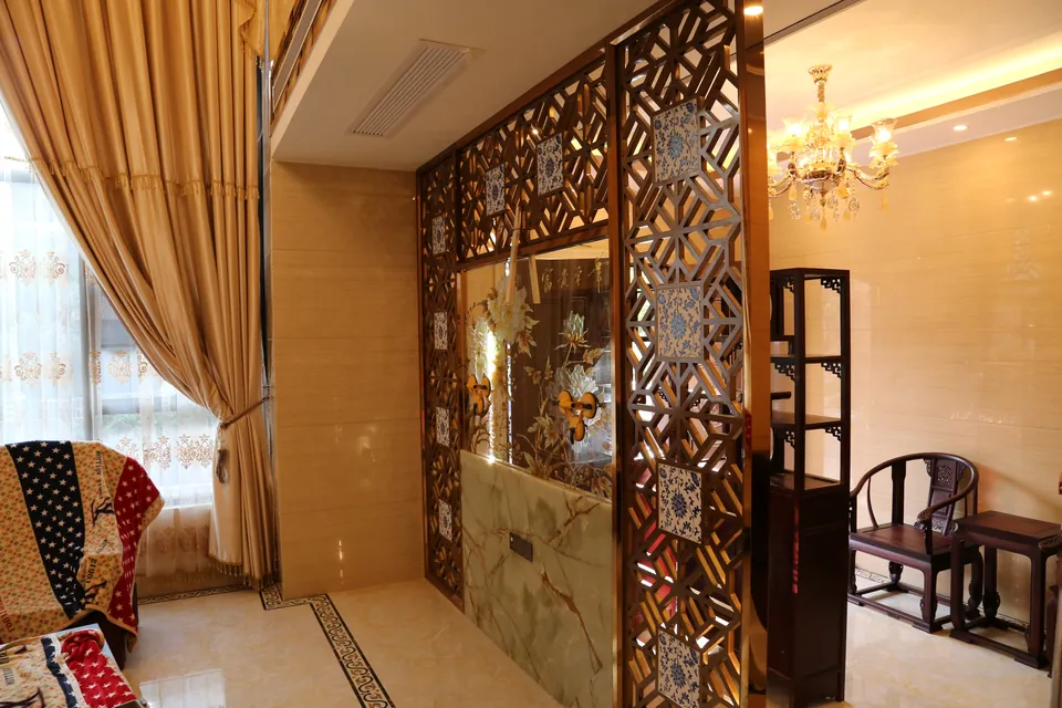 Completed decorative screen dividing two furnished rooms at Poly Xiangxueshan Villa.