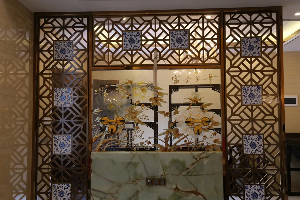 Front view of a completed geometric screen and stone console in the villa interior.