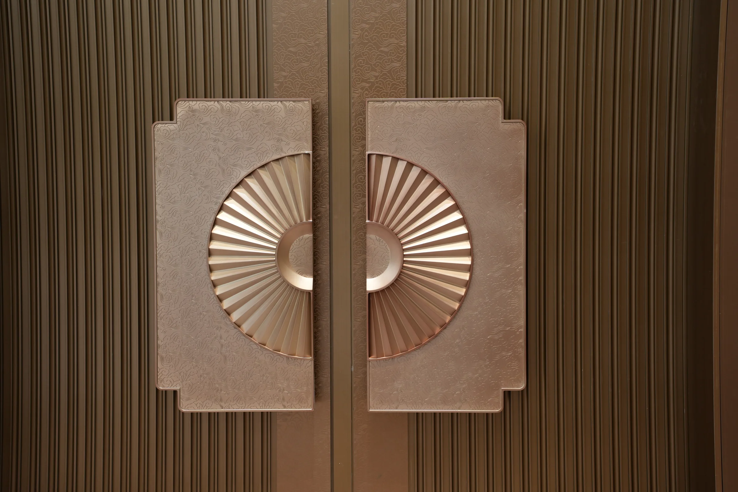 Sculpted door pulls and metal textures at Shantou convention center