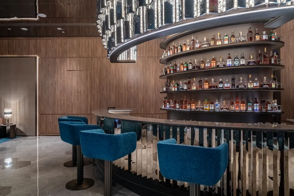 Hotel bar counter, display shelves and blue seating
