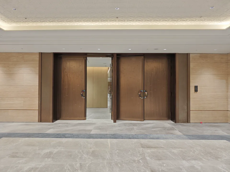 Wide view of completed patterned metal doors at Guangdong Olympic Sports Center.