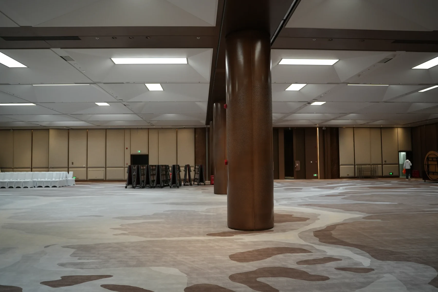 Hall ceiling, bronze-toned columns and paneled walls at Shantou International Convention and Exhibition Center.