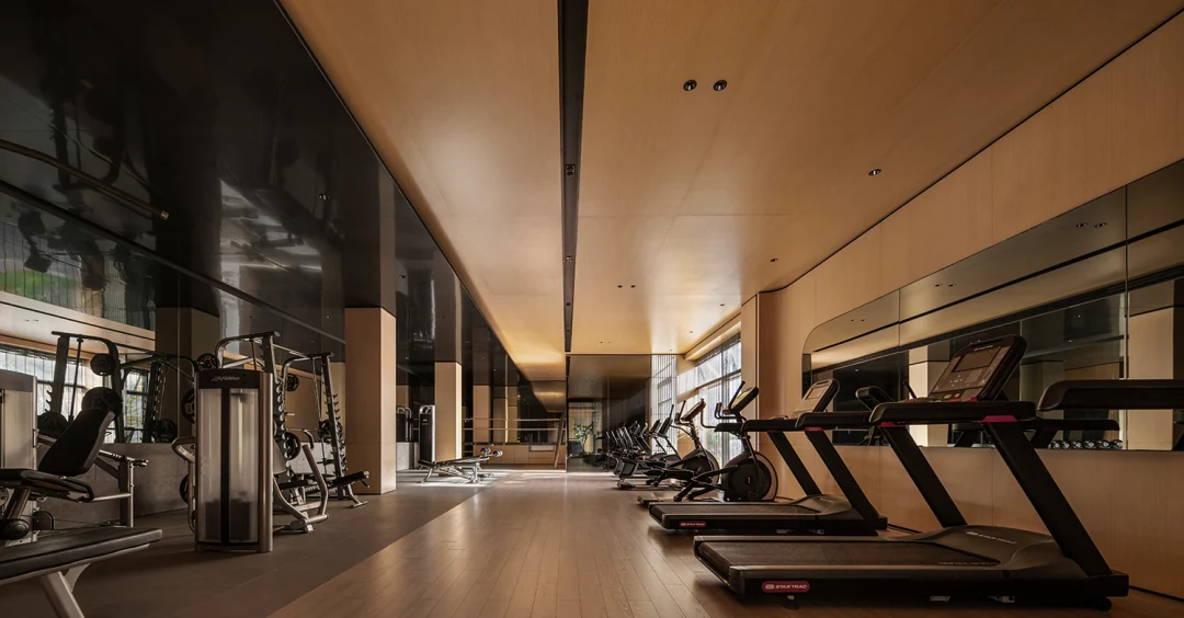 Application reference showing continuous ceiling planes above a fitness space.
