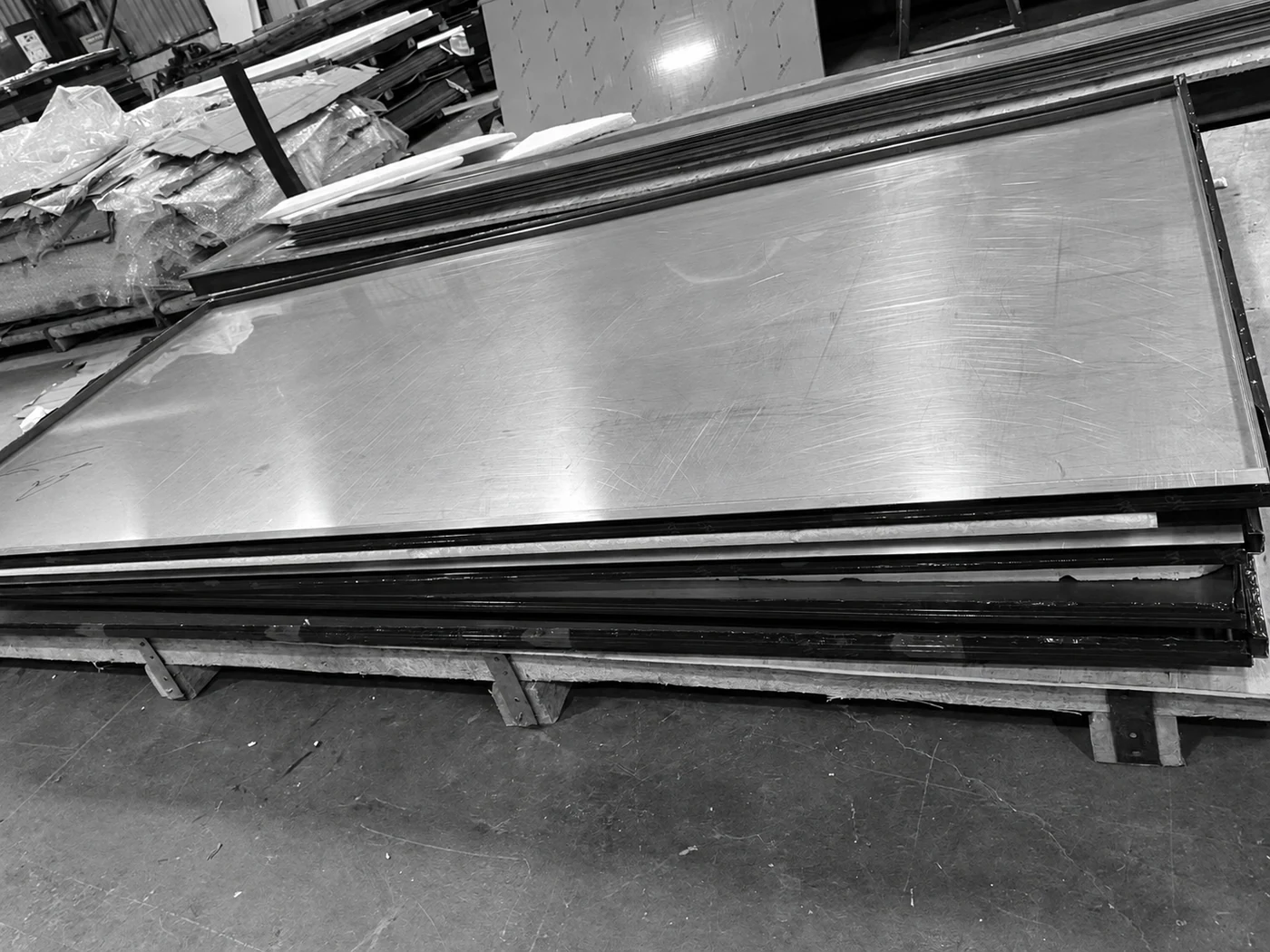 Finished metal panel stacks resting on a workshop pallet.