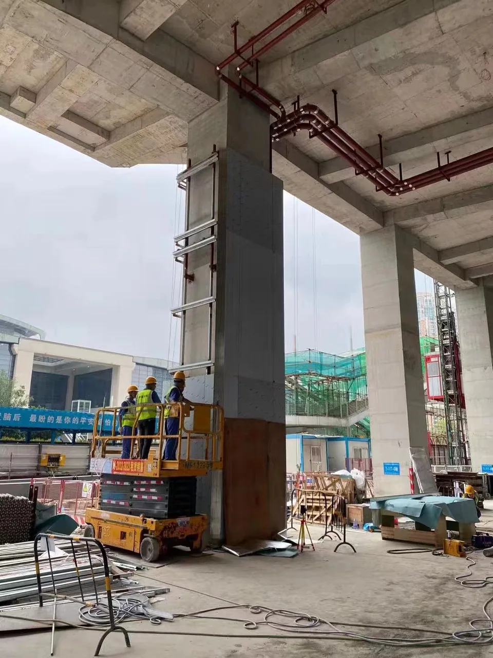 Existing columns, cladding panels and access equipment at an installation site