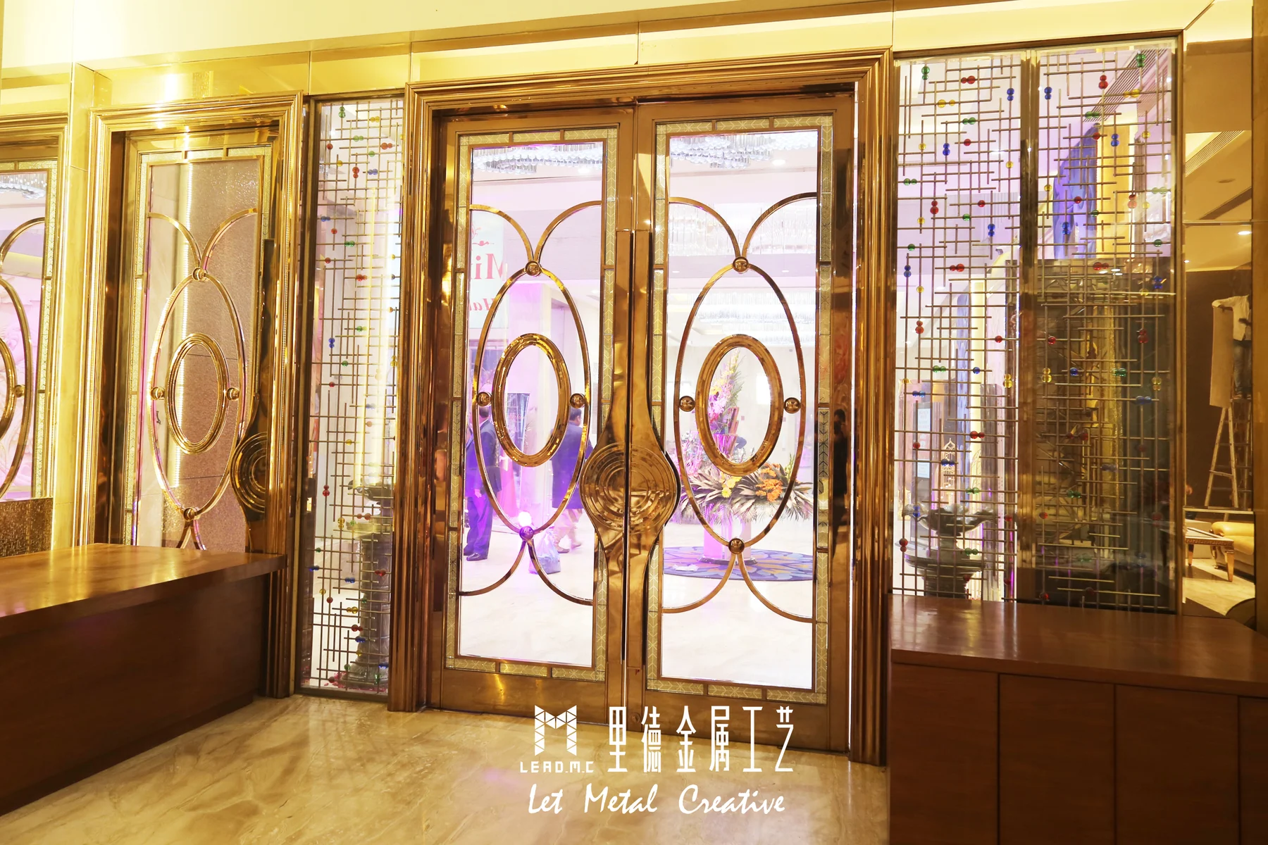 Decorative metal and glass banquet doors with circular pulls and geometric sidelights