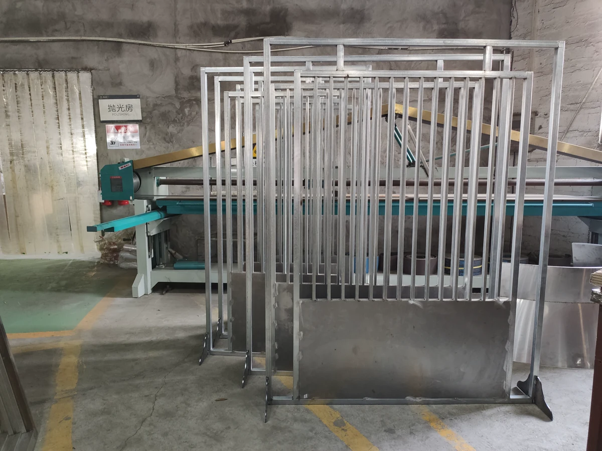 Batch of unfinished metal screen frames aligned for workshop inspection