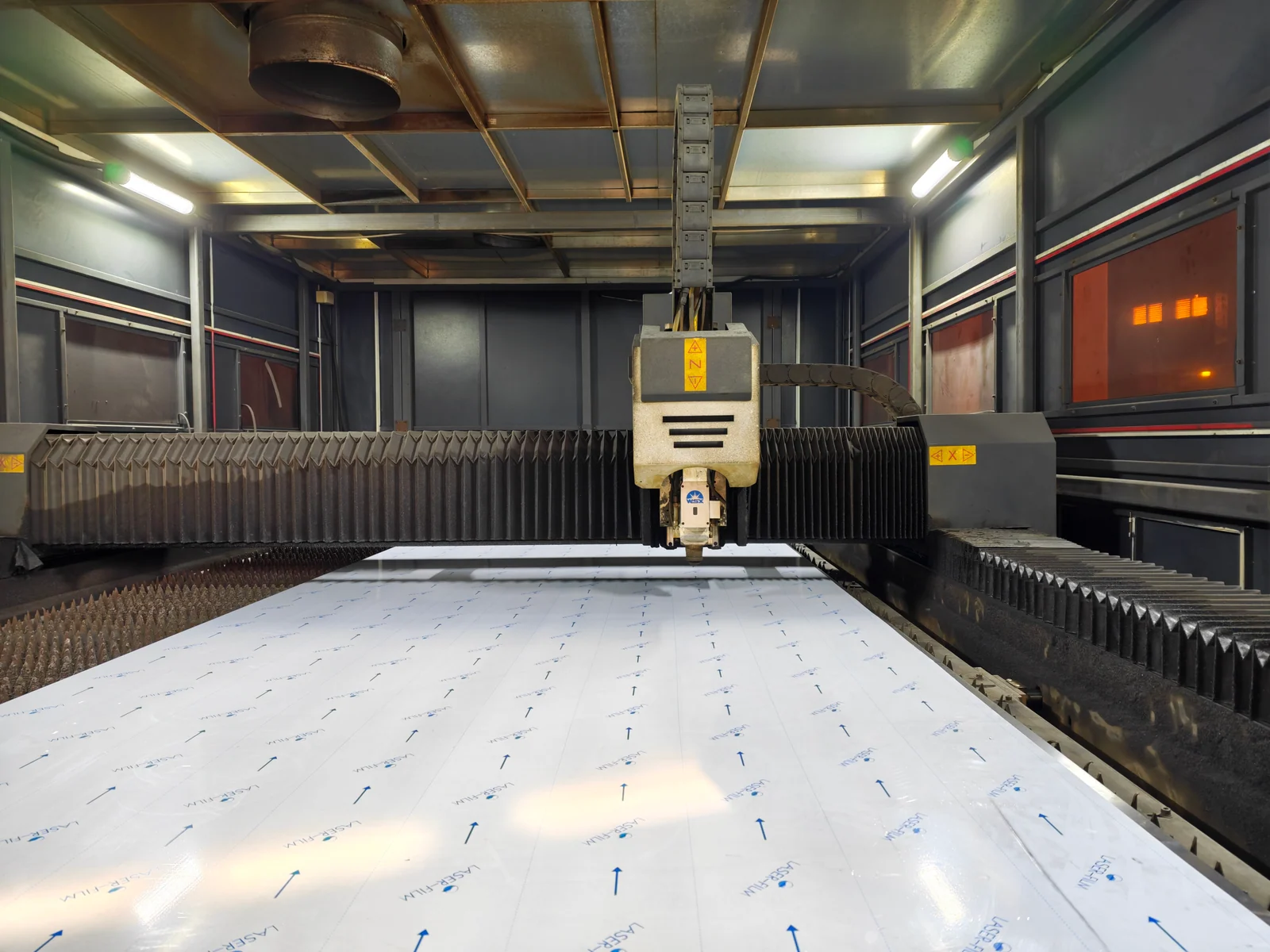 LMC Metal laser cutting equipment with sheet stock on the machine bed