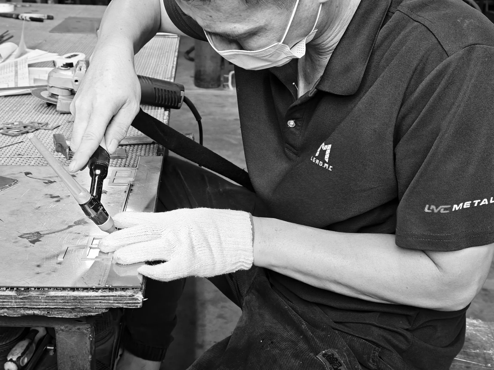 LMC Metal craftsman positioning a welding torch at a component joint