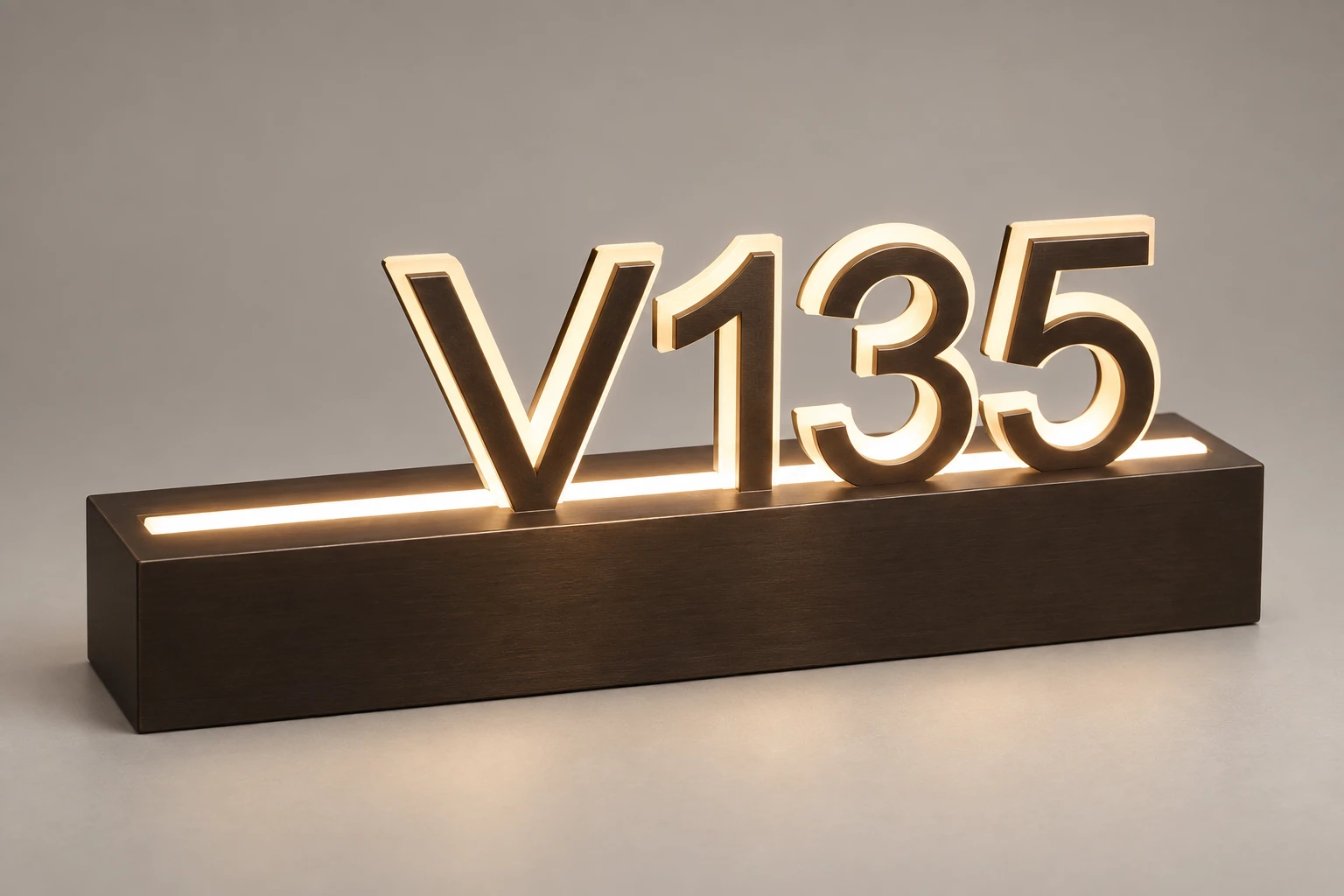 V135 room number with warm illuminated contours and a metal base