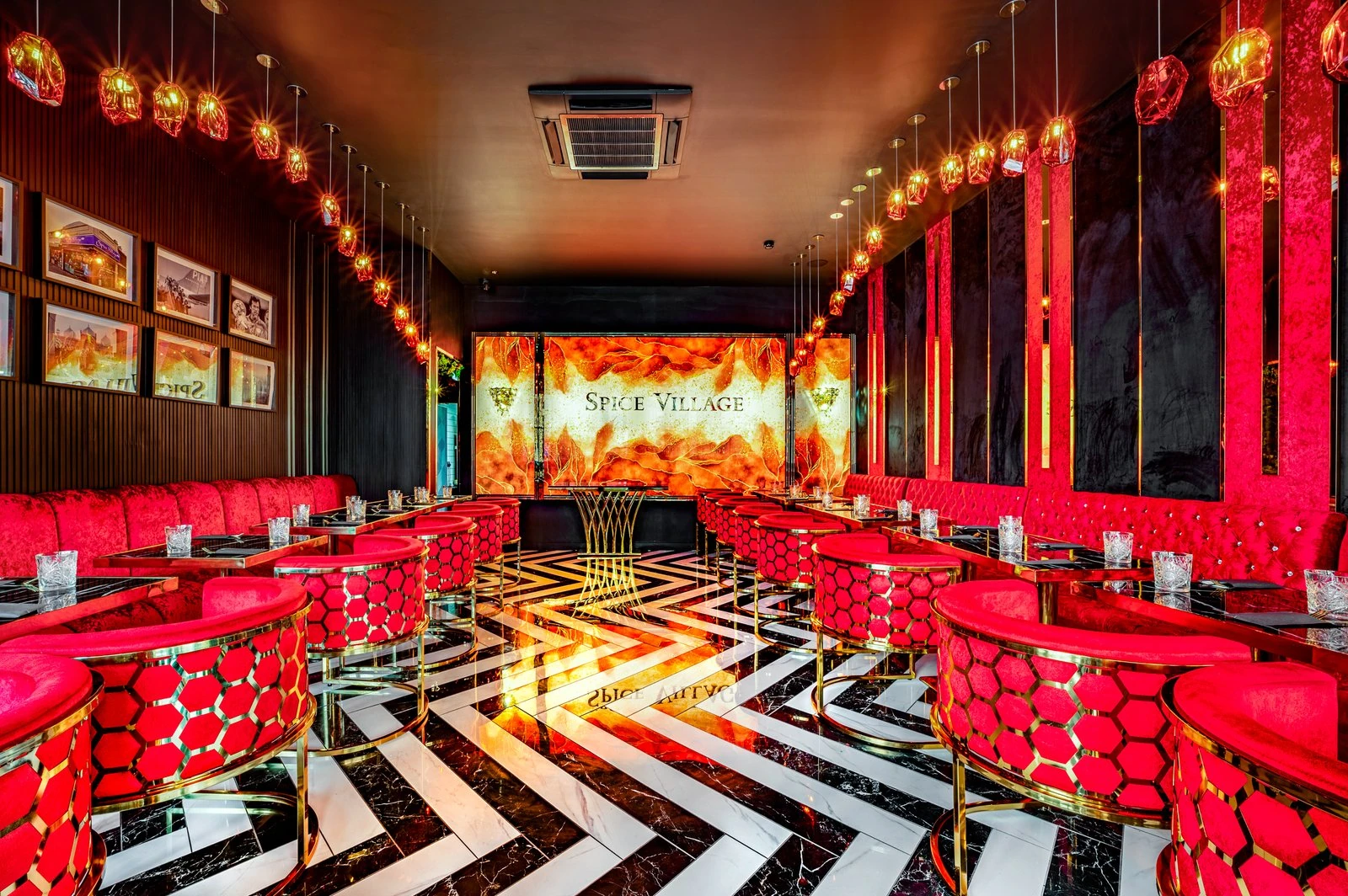 Spice Village Tooting restaurant in London, with branded signage, gold metal details and a red-and-black interior