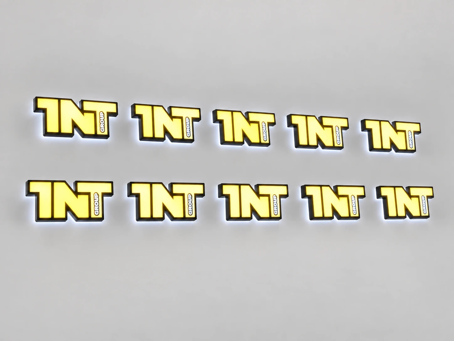 Ten yellow brand signs from the same batch with their lights on