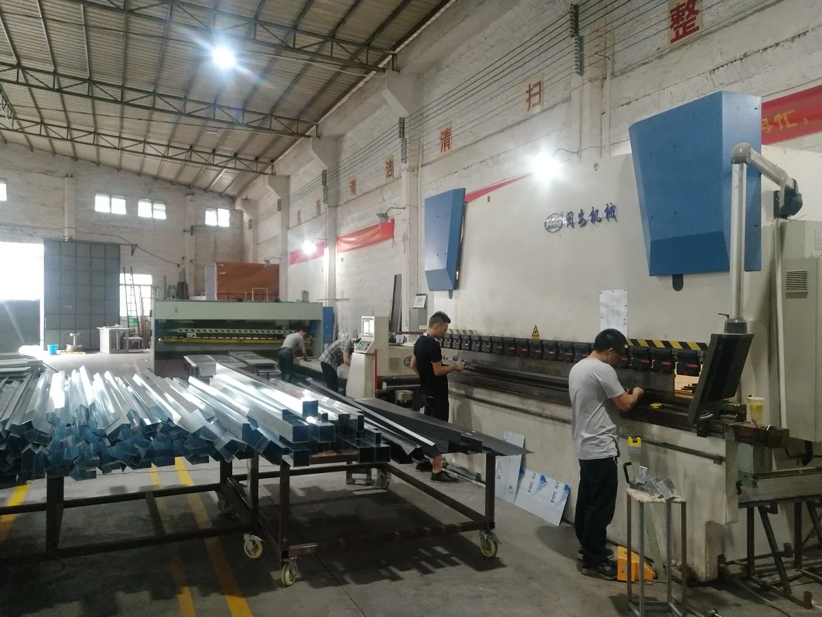 Press brake, operators and formed metal sections in the LMC workshop