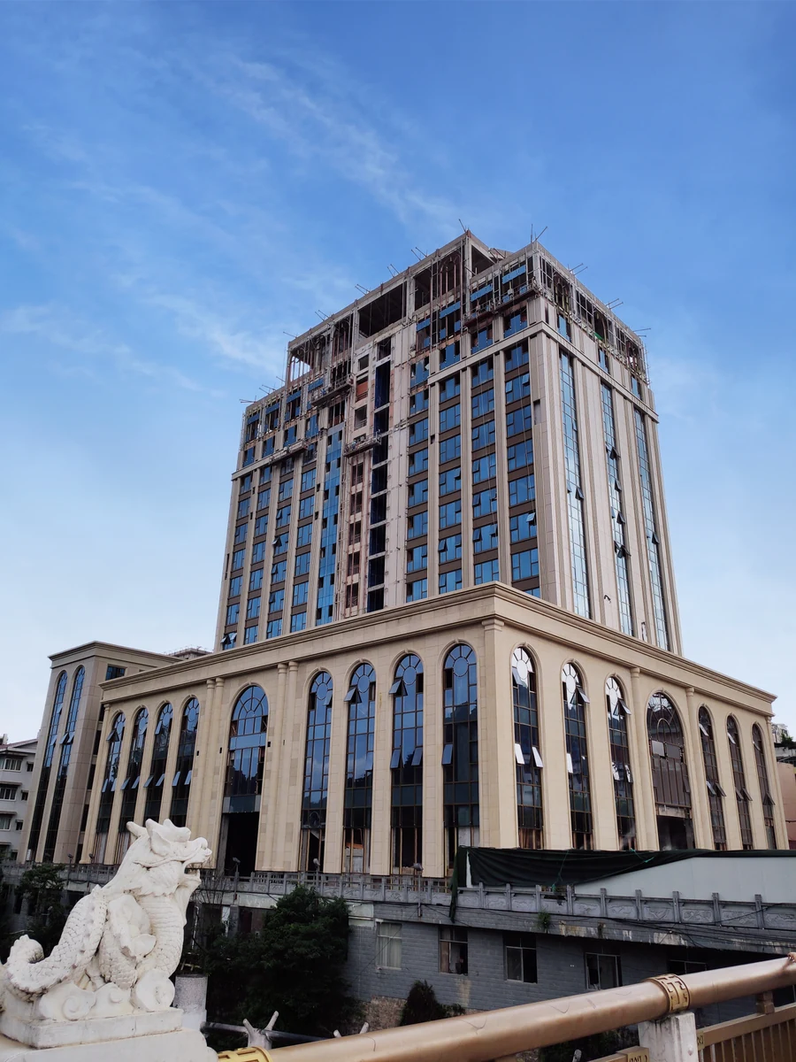 Tongren project facade construction photograph with work still in progress on upper floors